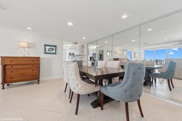 dining area featuring sink and light tile patterned floors