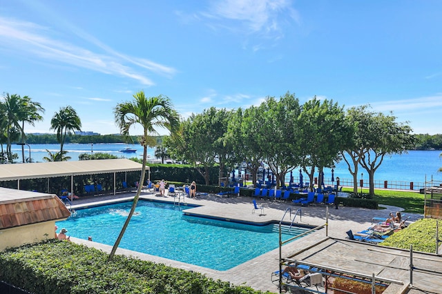 view of swimming pool with a patio and a water view