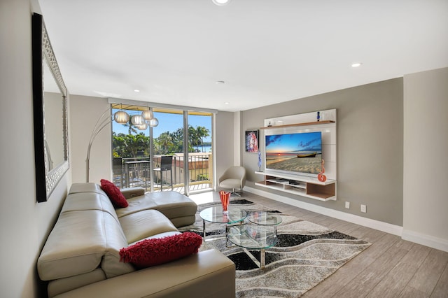 living room featuring floor to ceiling windows and light hardwood / wood-style floors