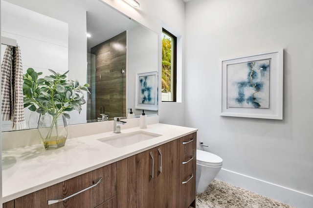 bathroom featuring vanity, toilet, and an enclosed shower