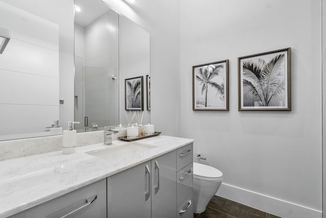 bathroom featuring vanity, walk in shower, and toilet