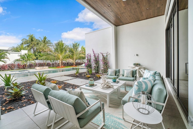 balcony with an outdoor hangout area and a patio