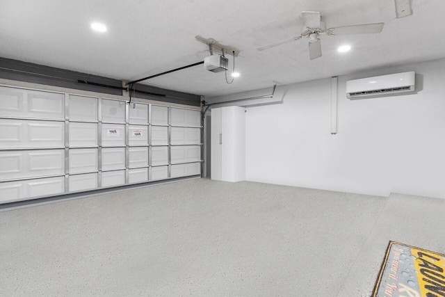 garage with a garage door opener, a wall mounted AC, and ceiling fan