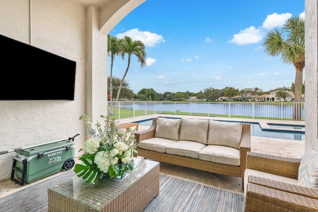 view of patio with a fenced in pool, outdoor lounge area, and a water view