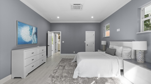 bedroom featuring crown molding and light hardwood / wood-style flooring