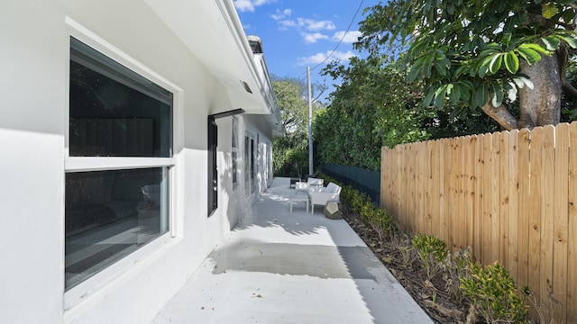 view of side of property featuring a patio area