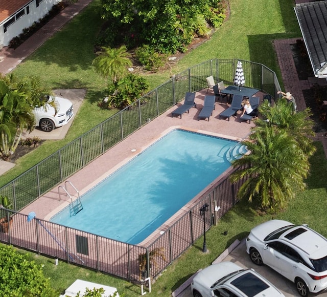 view of pool featuring a patio and a lawn