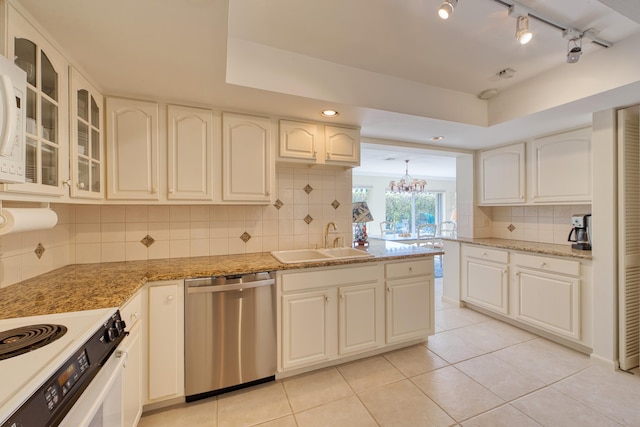 kitchen with sink, white cabinetry, tasteful backsplash, light stone counters, and stainless steel dishwasher