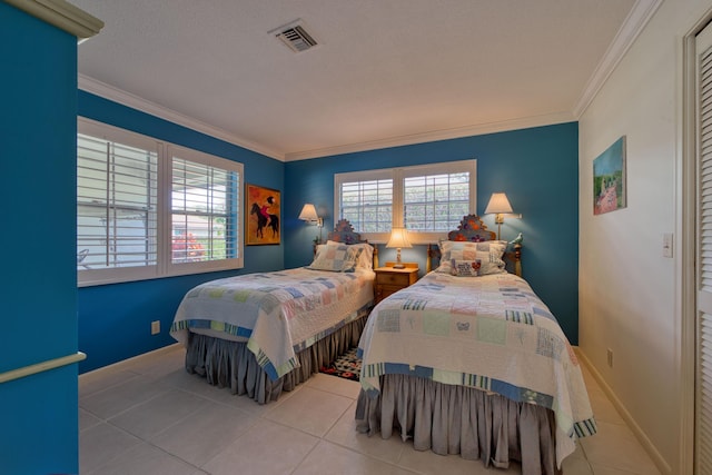 bedroom with ornamental molding and light tile patterned floors