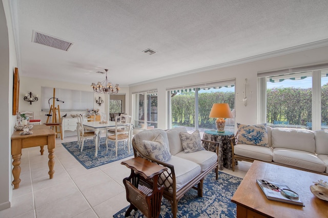 tiled living room with ornamental molding, a notable chandelier, and a textured ceiling