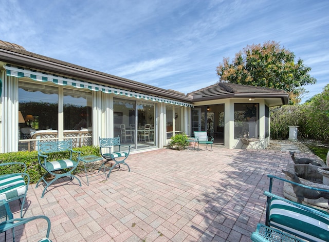 view of patio / terrace featuring a sunroom