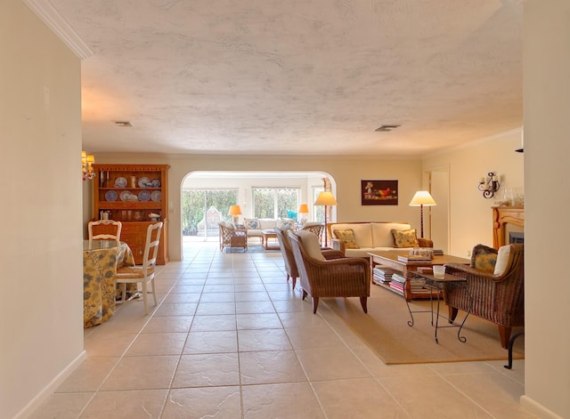 tiled living room featuring ornamental molding and a textured ceiling