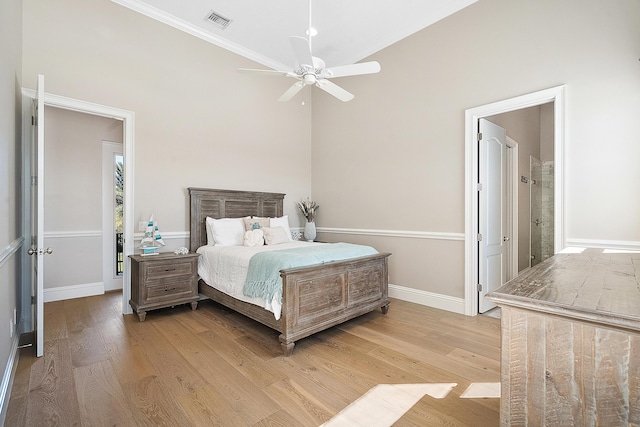 bedroom with visible vents, baseboards, light wood-style flooring, and a ceiling fan