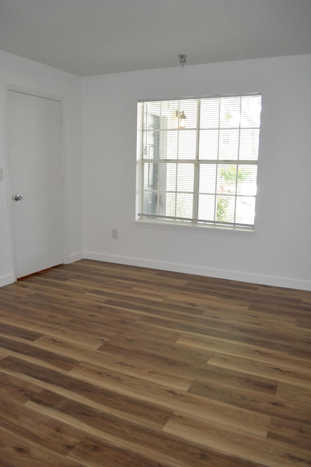 unfurnished room featuring dark hardwood / wood-style flooring