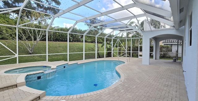 view of swimming pool with an in ground hot tub, a yard, a lanai, and a patio area