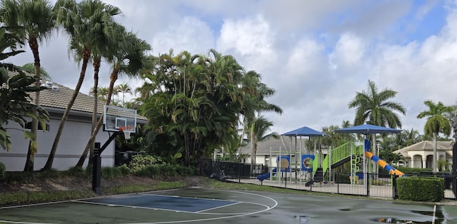 view of sport court featuring a playground