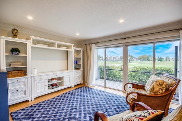 sitting room featuring ornamental molding and light hardwood / wood-style floors