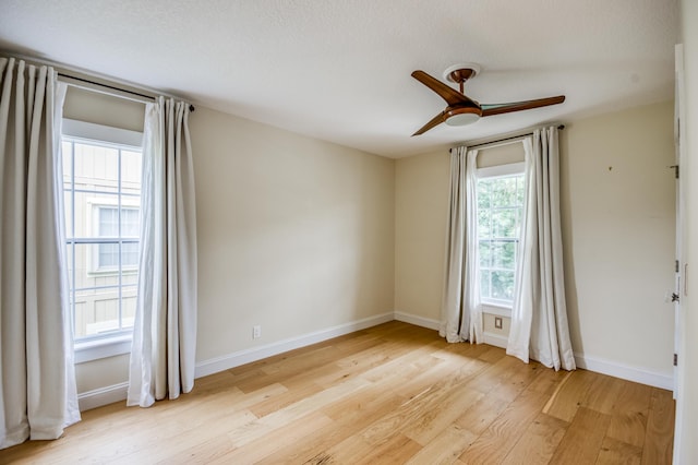 spare room featuring ceiling fan and light wood-type flooring