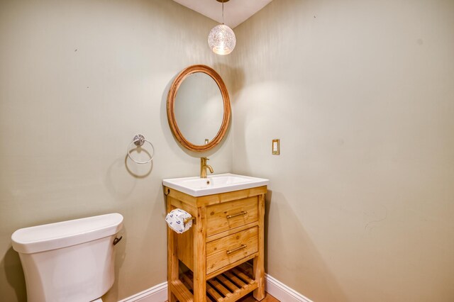 18520 SE Wood Haven Ln Unit L, Jupiter, FL 33469 - half bathroom featuring baseboards, vanity, and toilet