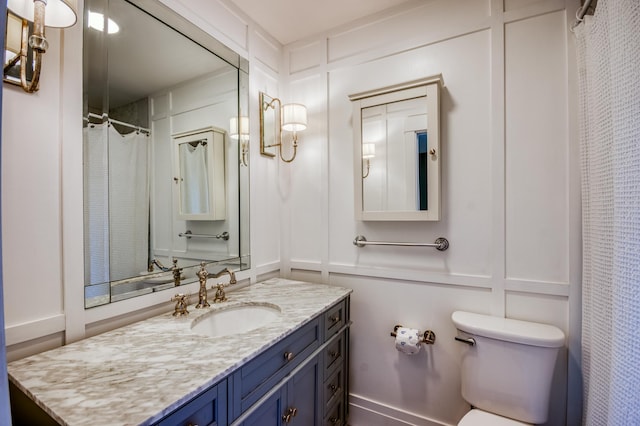 bathroom featuring vanity, walk in shower, and toilet