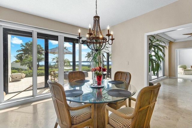 dining space with a textured ceiling and a chandelier