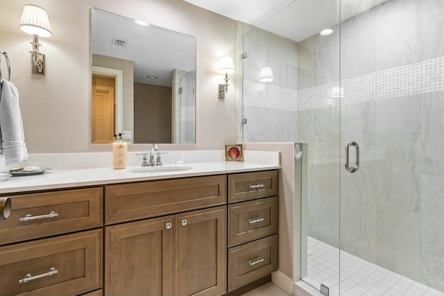 bathroom featuring vanity and a shower with door