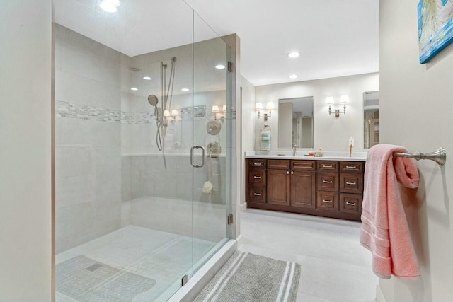 bathroom with vanity, an enclosed shower, and tile patterned floors