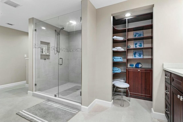 bathroom with walk in shower and vanity