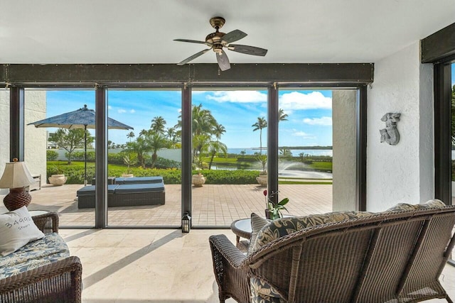 entryway featuring ceiling fan and a water view