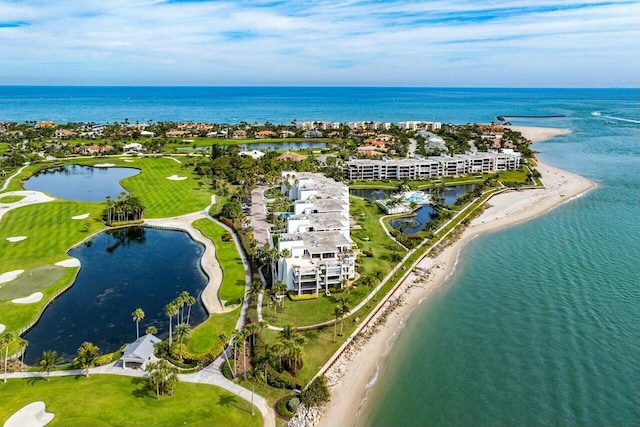 bird's eye view featuring a water view and a beach view