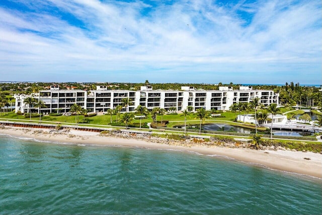 birds eye view of property with a water view and a view of the beach