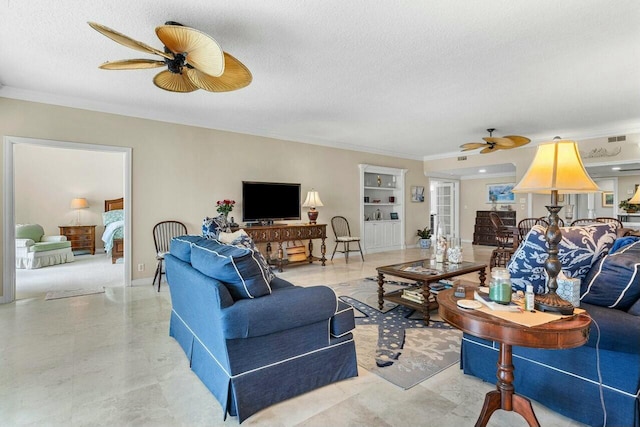 living room with ceiling fan, ornamental molding, and a textured ceiling