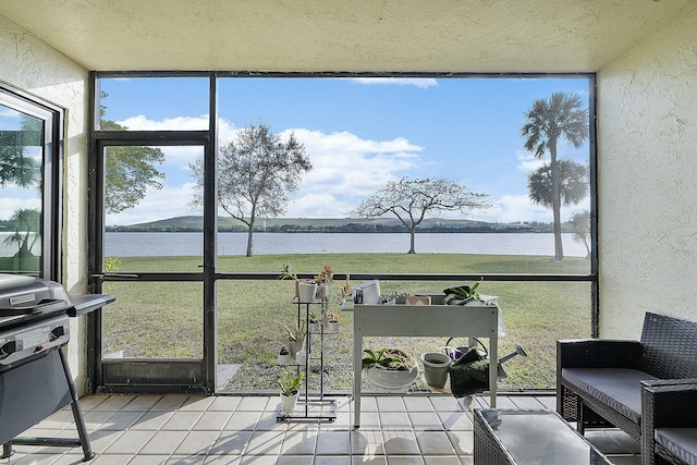 sunroom / solarium with a water view