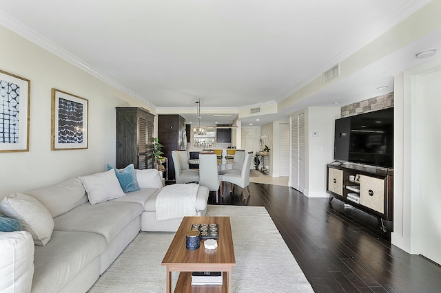 living room with crown molding and dark hardwood / wood-style floors