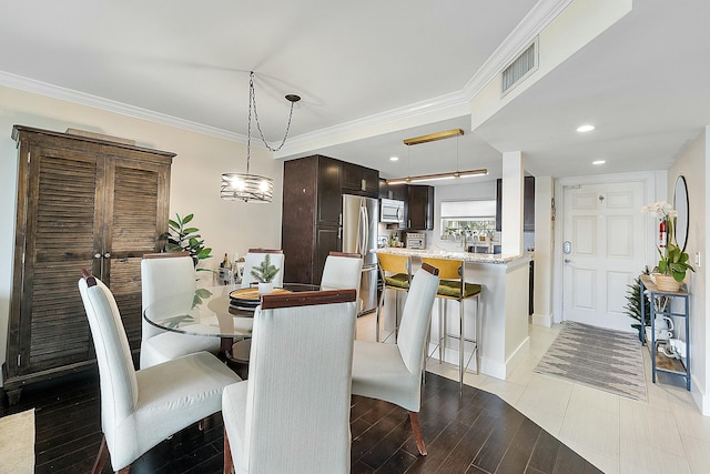 dining space featuring crown molding