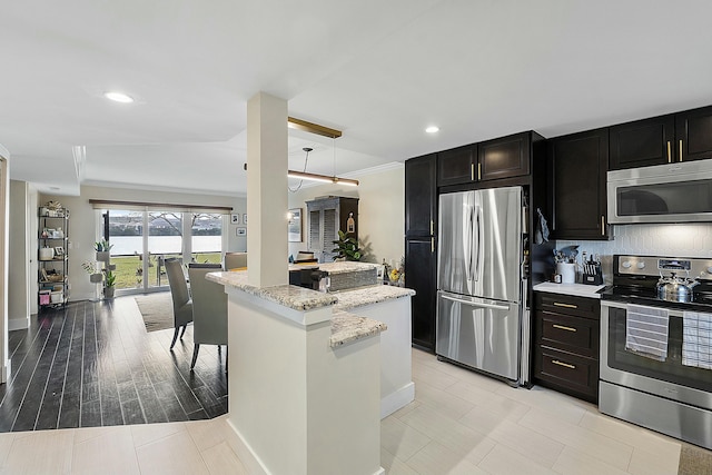 kitchen with crown molding, hanging light fixtures, appliances with stainless steel finishes, light stone countertops, and decorative backsplash