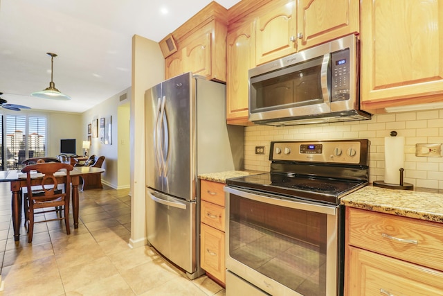 kitchen with pendant lighting, backsplash, light stone counters, stainless steel appliances, and light brown cabinets