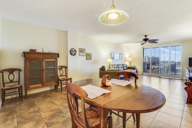 tiled dining room featuring ceiling fan