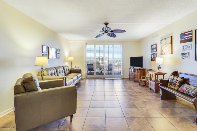 tiled living room with ceiling fan and a textured ceiling