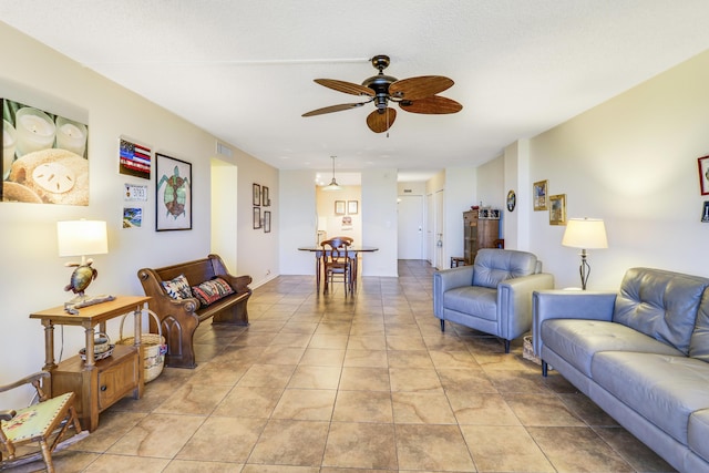 tiled living room with ceiling fan