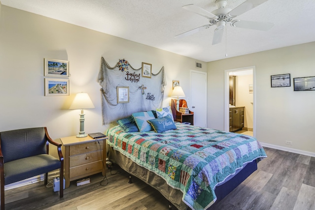 bedroom with ceiling fan, wood-type flooring, a textured ceiling, and ensuite bathroom