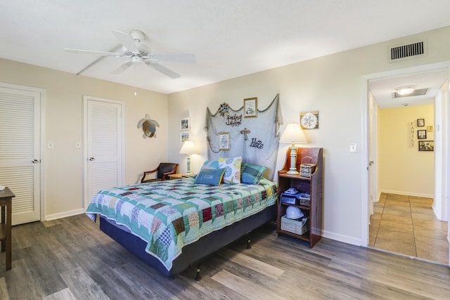 bedroom featuring dark hardwood / wood-style flooring and ceiling fan