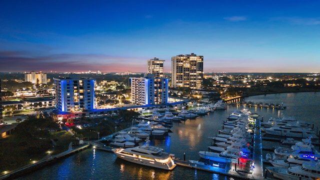 aerial view at dusk featuring a water view