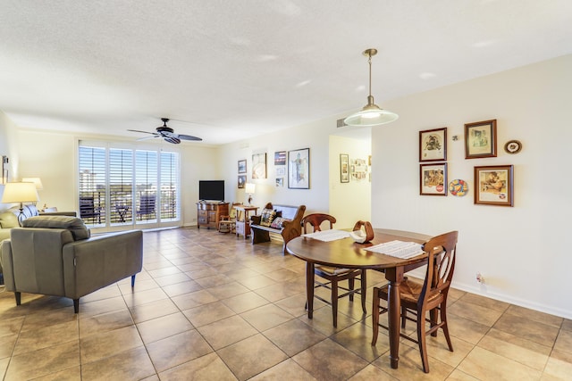 dining space featuring a textured ceiling, tile patterned floors, and ceiling fan