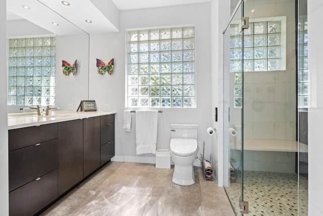 bathroom with tile patterned floors, vanity, toilet, and an enclosed shower