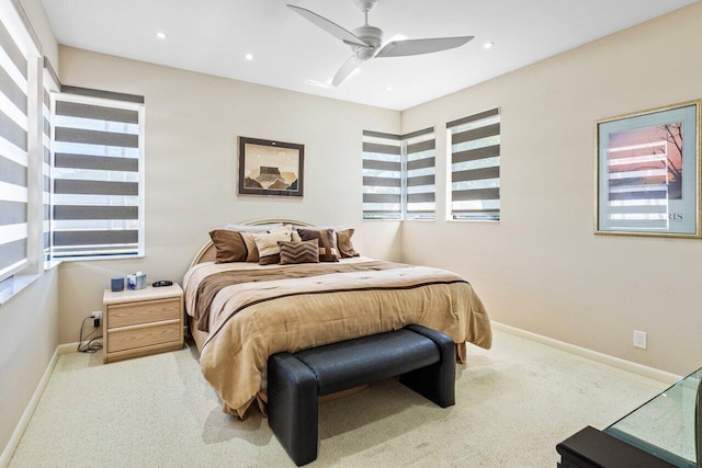 carpeted bedroom with multiple windows and ceiling fan