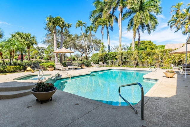 view of pool with a patio and an in ground hot tub