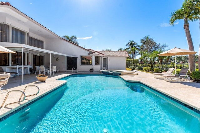 view of pool with a patio and an in ground hot tub