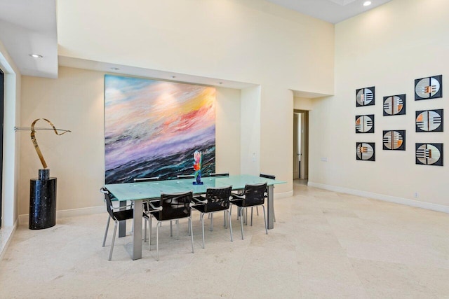 dining space featuring a high ceiling