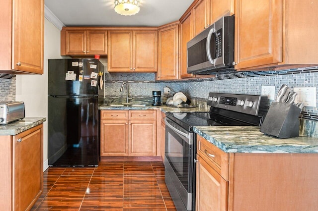 kitchen with decorative backsplash, brown cabinets, stainless steel appliances, stone counters, and a sink